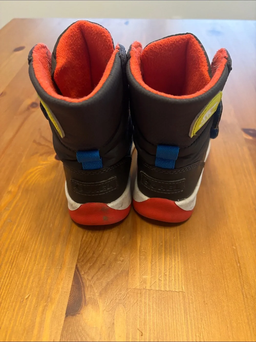 Sorel Kids Black Winter Boots with Red Lining and Red Soles